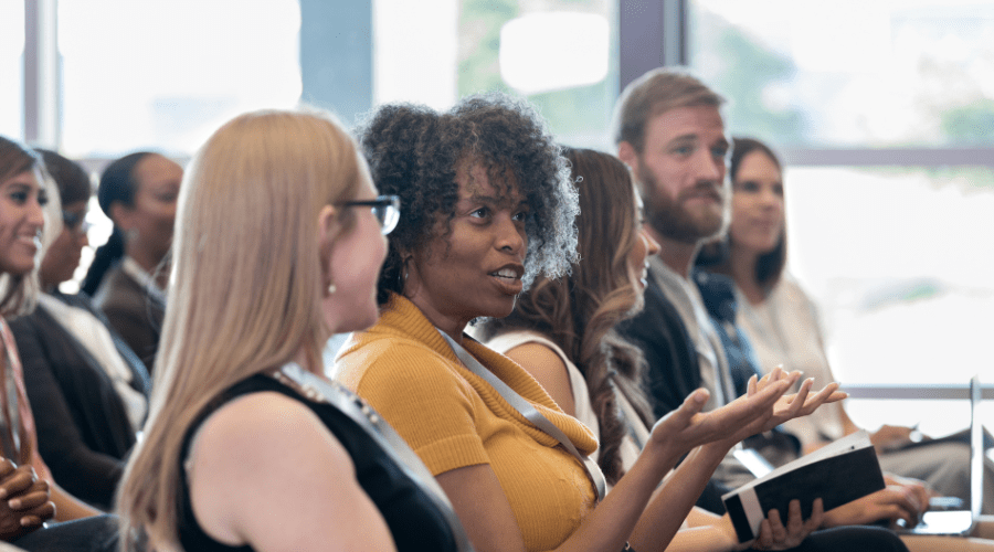 People ask questions at a conference.