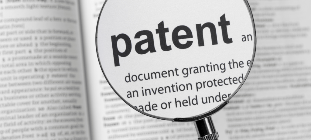 The word "patent" is magnified in a dictionary.