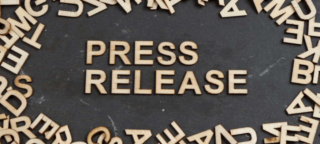 Wood letters spell the word, "press release."