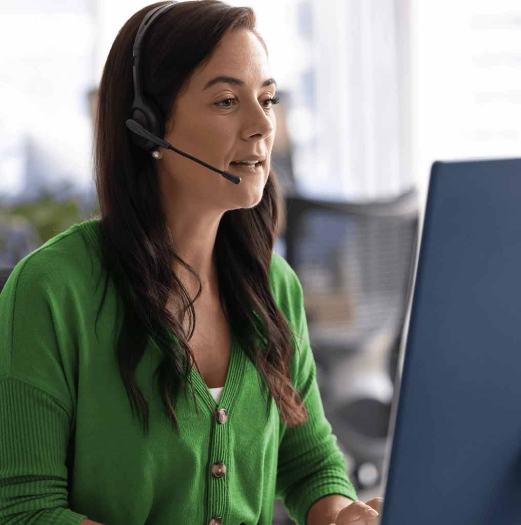 Operator on call with computer displaying Amtelco's answering service software