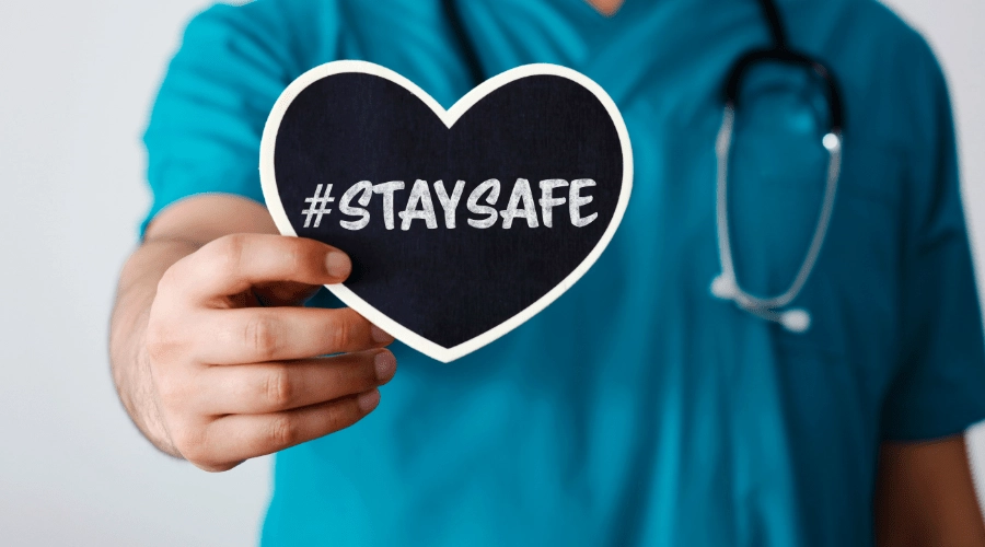 A doctor holds a sign about safety during National Safety Month.