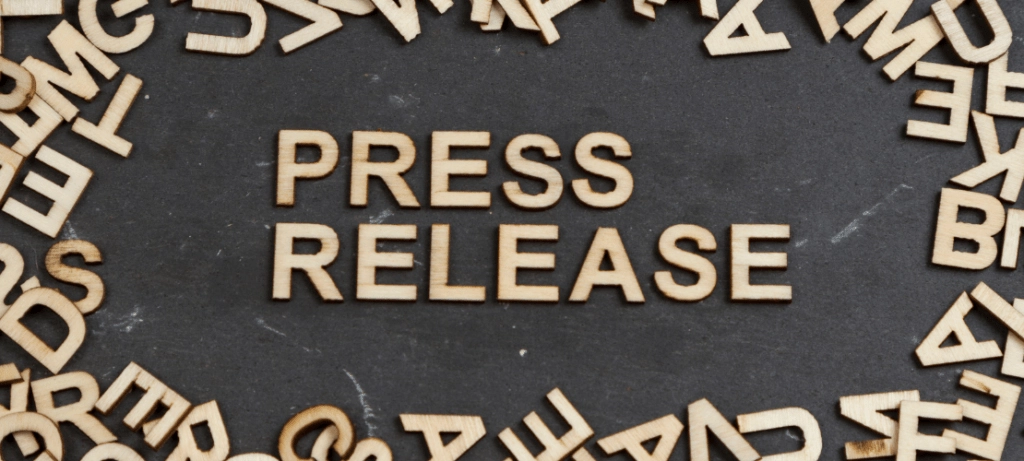Wood letters spell the word, "press release."