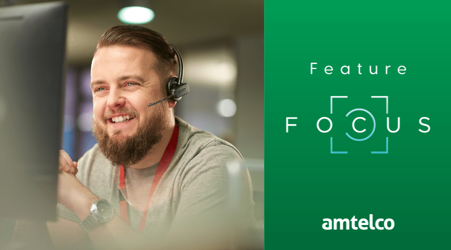 A man wearing a headset provides IT assistance.