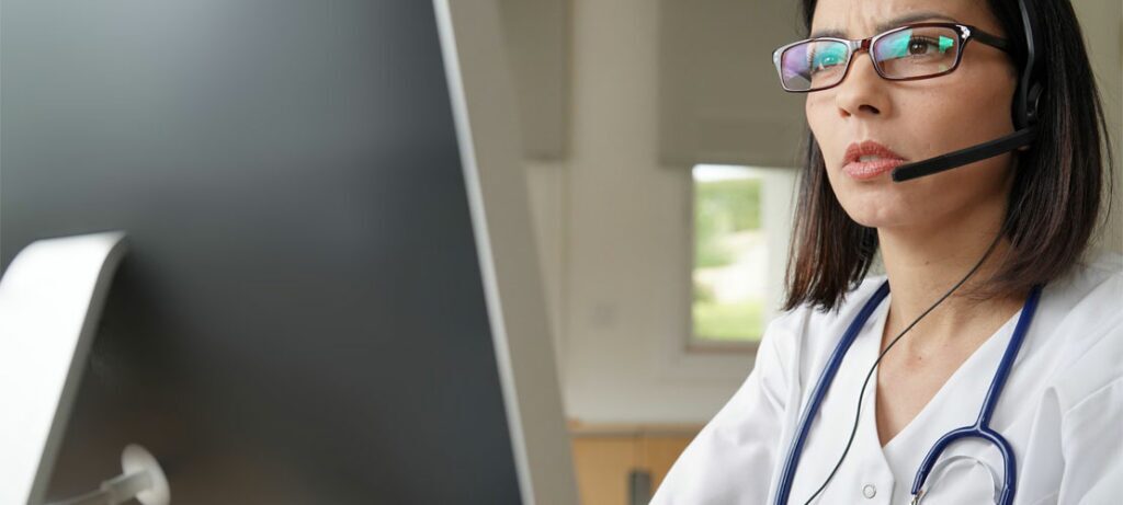 A telephone triage nurse works at a medical answering service.