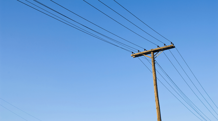 An older telephone pole with wires.