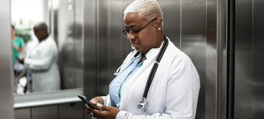 A doctor views a mass notification she received on her cell phone.