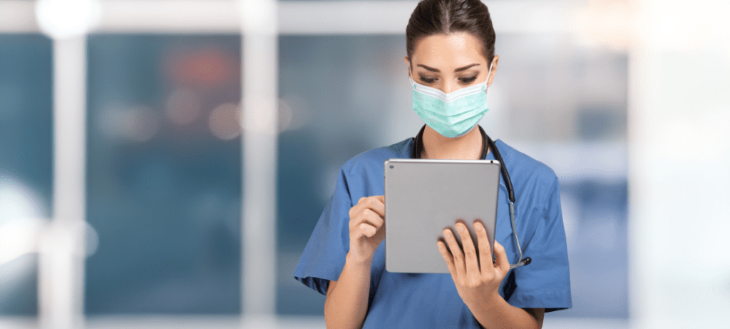 A hospital employee uses a secure messaging app on her tablet.