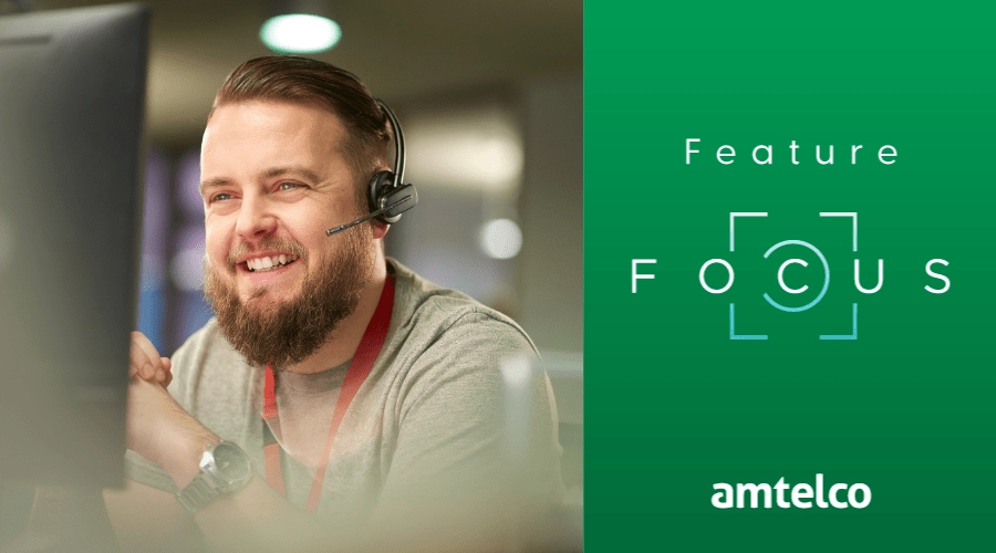 A man wearing a headset provides IT assistance.