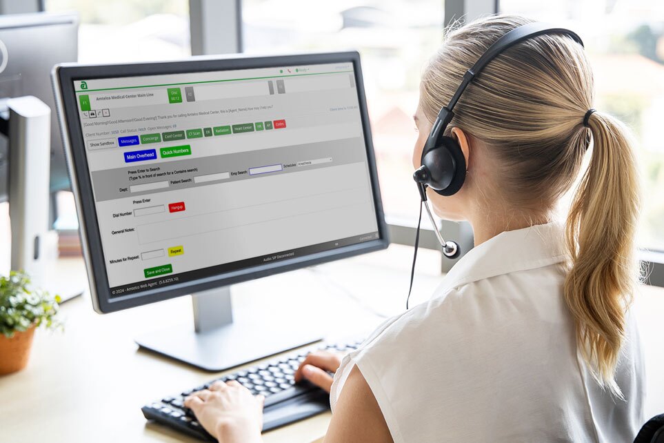 Answering service agent at operator console