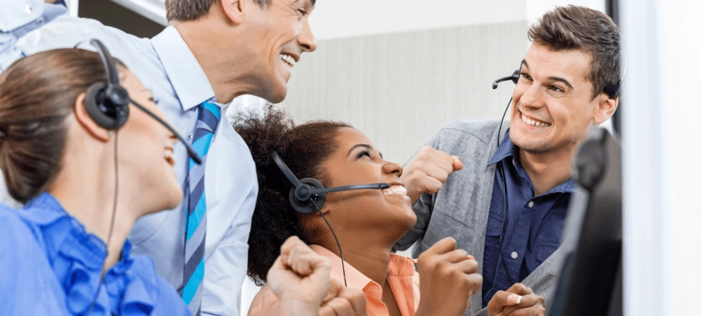 A group of contact center operators celebrate their leaderboard rank.