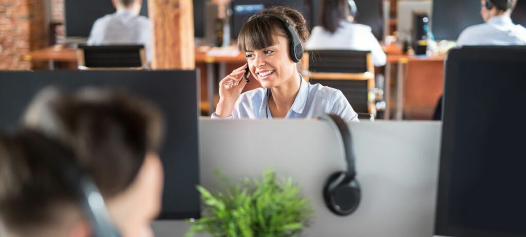 Female operator making call center callbacks to customers