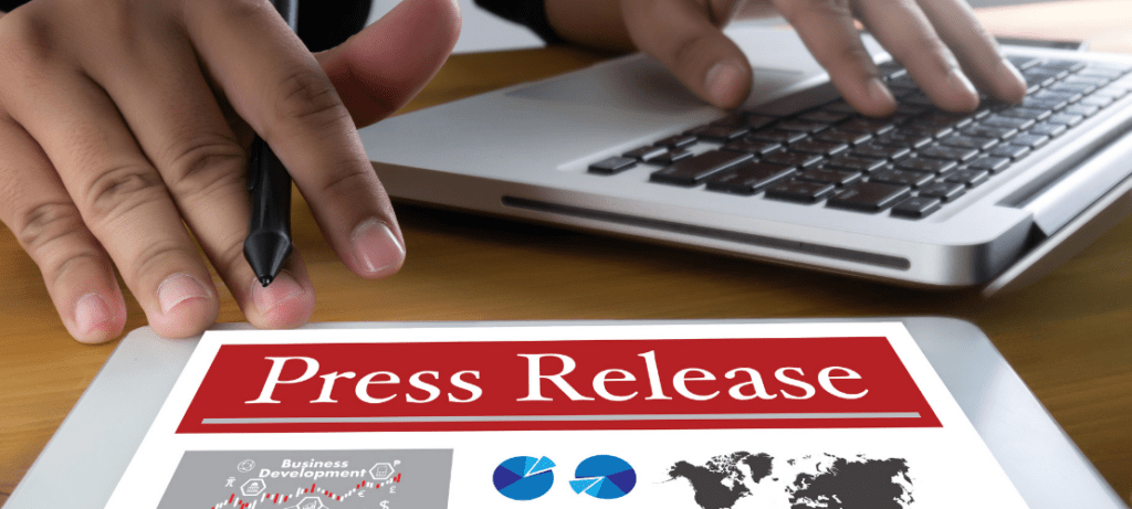 A person displays printed page of a press release.