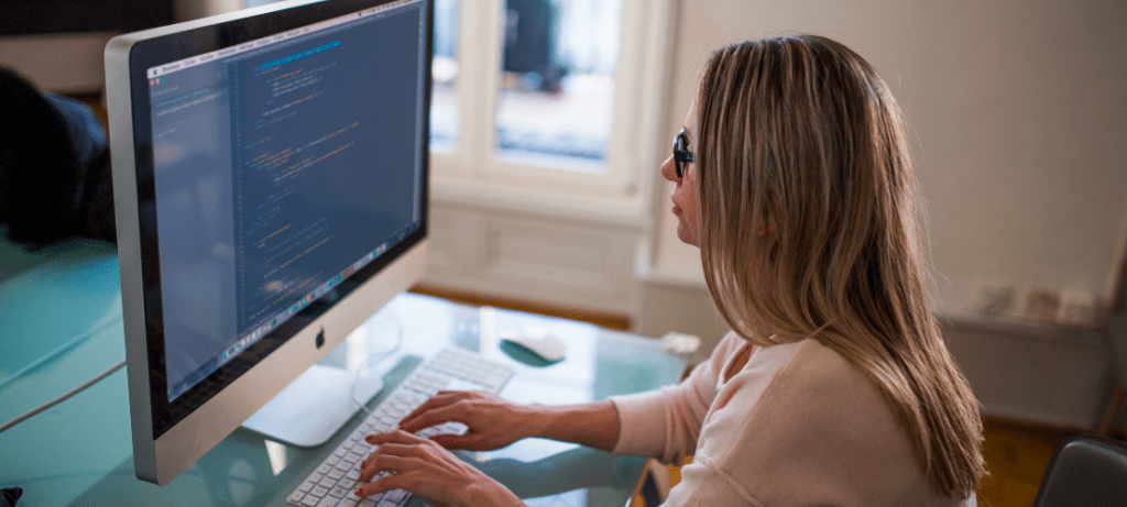 Woman coding MergeComm for inbound and outbound actions.