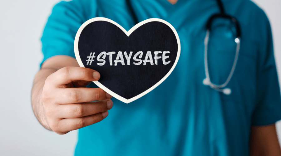 A doctor holds a sign about safety during National Safety Month.