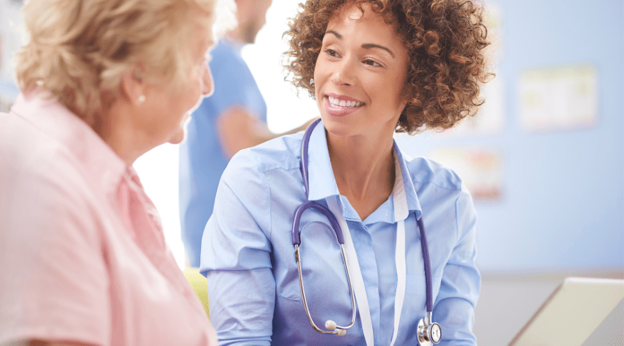 A patient and nurse communicate with each other in a healthcare setting.