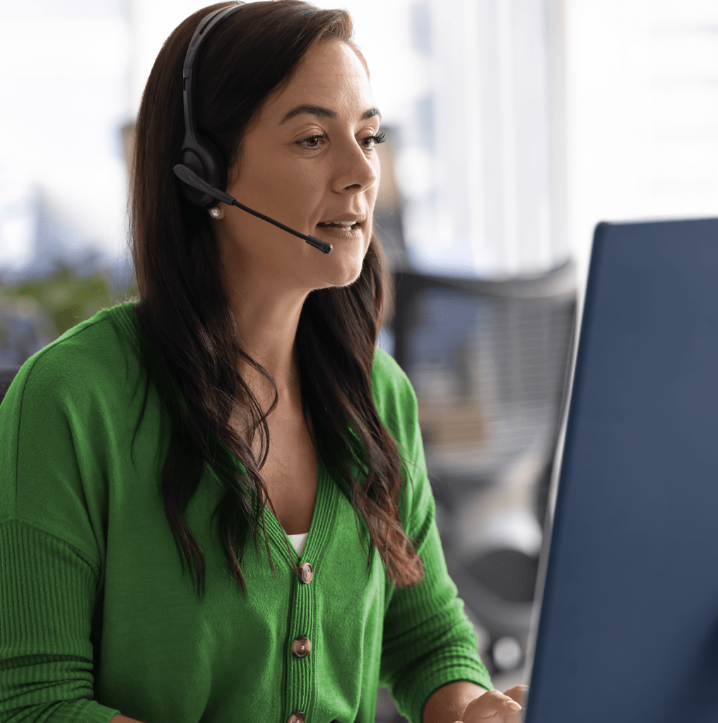 Operator on call with computer displaying Amtelco's answering service software