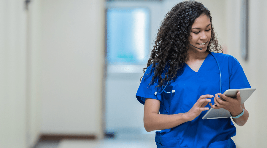 A patient advocate nurse uses a tablet with integrated communication software.