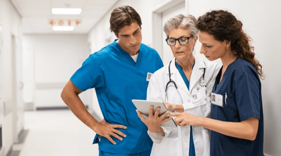 A group of medical professionals view a secure message on a tablet.