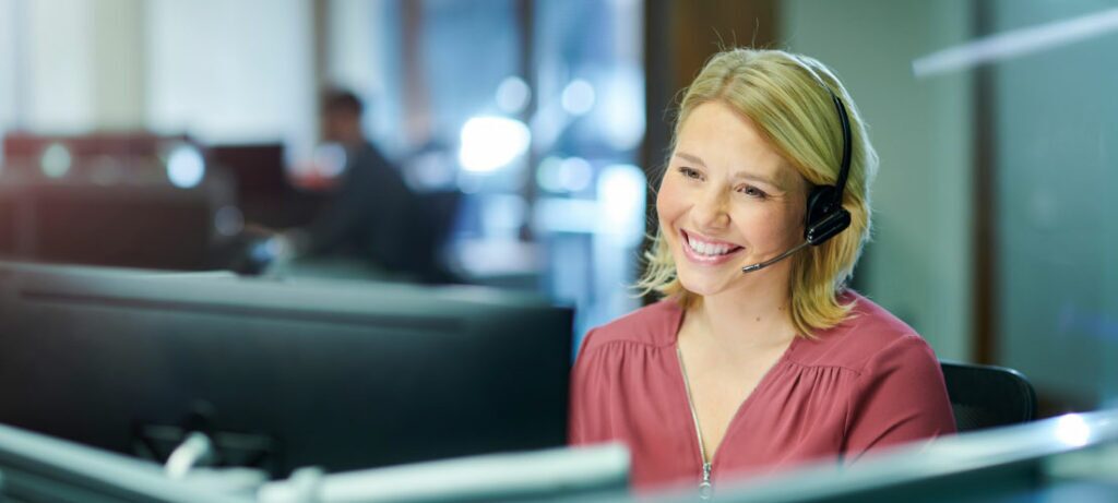 Female call center agent using customized call center software to answer calls