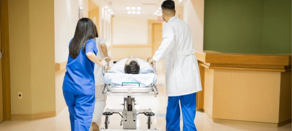 Hospital staff transfer a patient to another room.