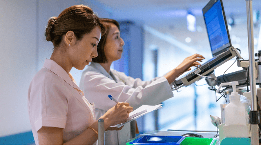 A doctor and nurse view notifications about a patient.