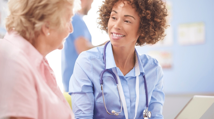 A patient and nurse communicate with each other in a healthcare setting.