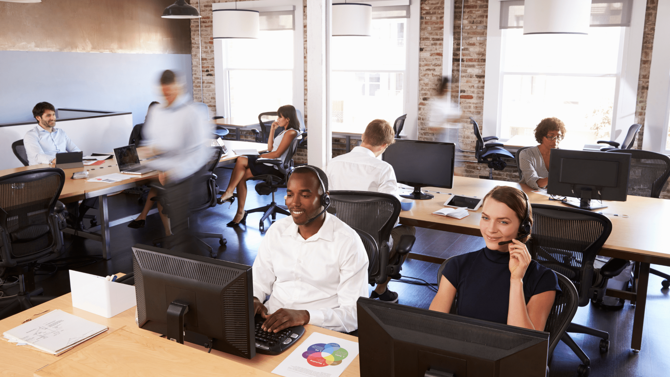 A group of transfer coordinators work at a patient transfer center.