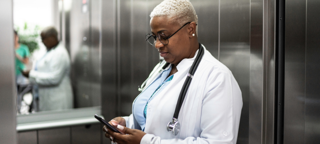 A doctor views a mass notification she received on her cell phone.
