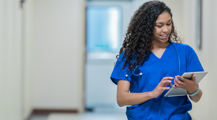 A patient advocate nurse uses a tablet with integrated communication software.