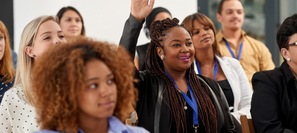A group of people attend a conference.