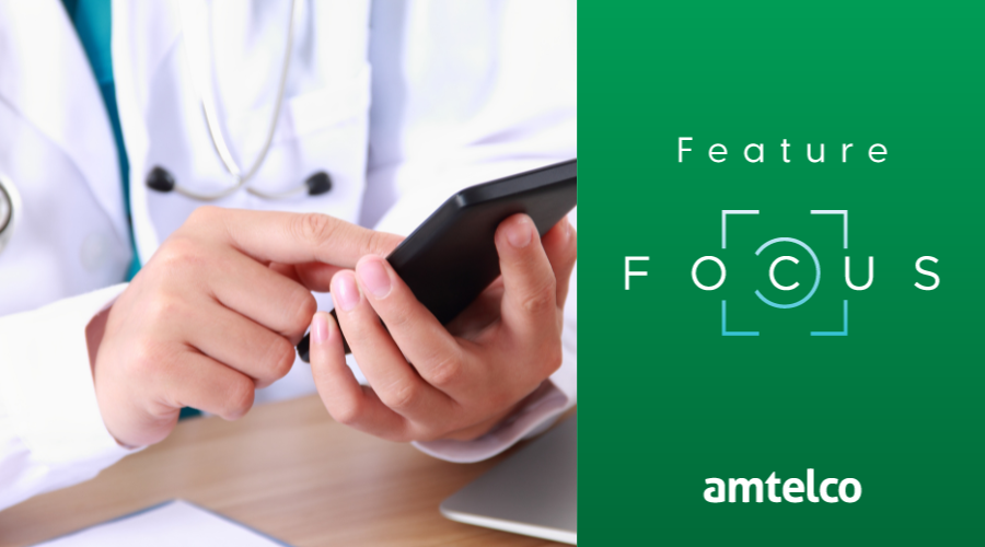 A doctor with a cell phone uses Amtelco's Smart Paging.