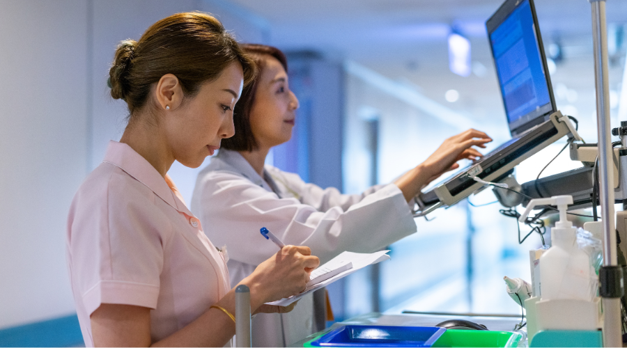 A doctor and nurse view notifications about a patient.